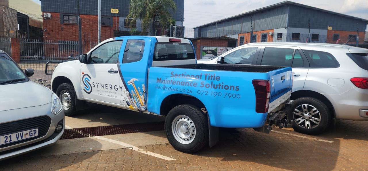 Synergy service bakkie parked, rear three-quarter view